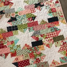 a close up of a quilt on the floor