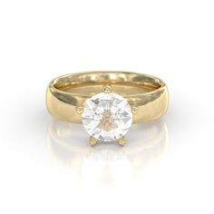 a yellow gold engagement ring with a round cut diamond in the center, on a white background