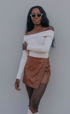 Looking for the cutest skirt of the season? The Give Me the Light Skirt is a high rise, wrap brown leather skirt with bronze studs and built in shorts. Pair with a bodysuit and tall boots. 

Heather is 5'9" and is wearing size small

size small measurements: 28" waist | 14.5" length

100% polyester lining | 100% polyurethane shell



PRODUCTS ON SALE ARE FINAL SALE! Feel free to email us at orders@shopriffraff.com or DM us with any questions regarding fit, styling, or our return poli Light Brown Leather Skirt Outfit, Brown Mini Leather Skirt Outfit, Brown Leather Skirt Outfit Fall, Tan Skirt Outfit, Leather Skirt Outfit Fall, Mini Leather Skirt Outfit, Tan Skirt Outfits, Fall Skirt Outfits With Boots, Beige Top Outfit