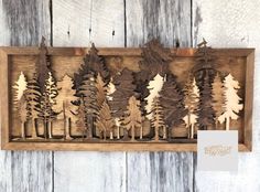 a wooden cutout of trees in a box