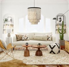 a living room filled with furniture and a large cactus hanging from the ceiling above it