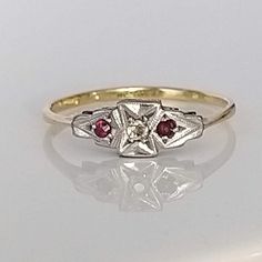 A beautiful understated ruby, diamond and platinum solid gold ring. The lovely rubies are a rich red in colour, complemented by a wonderfully bright old cut diamond which sparkles superbly in natural daylight. Perfect as a gift or for a special special occasion. ▪ Overall Condition: Excellent ▪ Metal: 18ct Gold & Platinum ▪ Gem: Ruby ▪ Gem: Diamond ▪ Gem Cut: Old & Round Cut ▪ Gem Colour: Red & White ▪ Ring Size UK: O.5 ▪ Ring Size US: 7.50 ▪ Marked: Stamped 18ct & Plat ▪ Resizing: Quotation Available ▪ Weight: 1.5gms ▪ Insurance Estimate: £735 ▪ Payment Layaway Plan Available: Yes ▪ Full Detailed Appraisal: Quotation Available As a qualified Gemmologist and Jeweller with over 20 years experience in the jewellery  industry, each jewel is chosen for its  'quality, beauty and interest'... As Classic Red Diamond Ring With Single Cut Diamonds, Classic Red Ruby Ring With Single Cut Diamonds, Antique Diamond Cut Ruby Ring For Anniversary, Antique Ruby Ring With Diamond Cut For Anniversary, Vintage Ruby Ring With Diamond Cut, Vintage Ruby Ring With Diamond Accents, Red Ruby Ring With Single Cut Diamonds, Hallmarked Vintage White Gold Ruby Ring, Vintage Hallmarked White Gold Ruby Ring