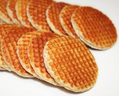 several waffles are arranged on a white surface