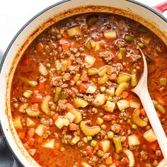 a large pot filled with stew and vegetables