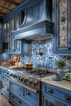 a kitchen with blue cabinets and tile backsplashes on the counter tops, along with an oven