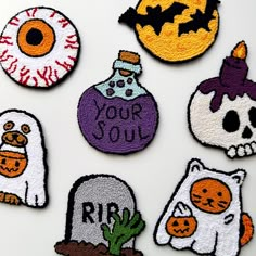 embroidered patches depicting halloween related items on a white surface with words your soul written in the center