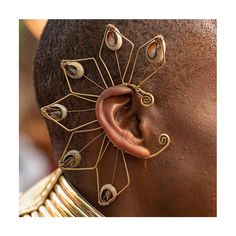 Make a statement with our authentic Ear Edornment. Handmade using brass and cowrie shells from the Indian Ocean. Cowrie shells were once traded as currency in West Africa and stood as a symbol of power. Adjustable. One size fits all. A Luangisa Exclusive. Unique Fair Trade Jewelry For Festivals, Traditional One-of-a-kind Brass Jewelry, Artisan Bronze Jewelry For Festivals, Ceremonial Unique Bronze Jewelry, Bohemian Bronze Jewelry For Ceremonial Occasions, Unique Brass Jewelry For Ceremonial Occasions, Brass Jewelry For Rituals And Festivals, Unique Ceremonial Brass Jewelry, Artisan Gold Jewelry For Festivals