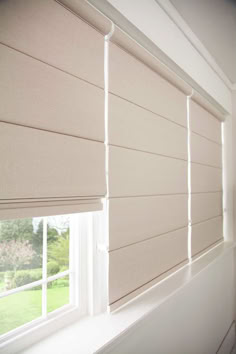 an open window with roman shades on it