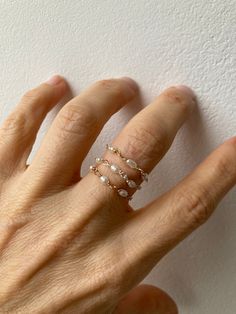 This little chain ring offers a fresh take on a traditional band ring. It is also very lightweight and comfortable to wear.  D E T A I L S *Made with AAA grade cultured freshwater rice pearls. These are very small measuring between 2- 4mm x 1.5mm. *Choose between a 14k gold filled, rose gold filled or sterling silver chain. *Gold fill is a wonderful alternative to gold and unlike gold plating does not rub off. *Choose the size you prefer from the drop down menu.  *Ring comes with a matching crystal information card and is ready for gifting. S I Z I N G * H E L P:  The the most accurate way to determine your ring size is to be professionally measured by a jeweller.  There are also several at-home sizing tools and tips to help find your ring size. The MOST COMMON RING SIZES for women are siz Dainty 14k Gold Filled Wire Wrapped Rings, Rose Gold Pearl Jewelry With Wire Wrapped Detail, Delicate 14k Gold Filled Midi Rings In Rose Gold, Delicate 14k Rose Gold Filled Midi Rings, Dainty 14k Rose Gold Pearl Ring, Delicate Rose Gold Pearl Ring In 14k, Elegant Everyday Wire Wrapped Rings, Dainty Wire Wrapped Rings, Delicate Pearl Charm Ring Jewelry