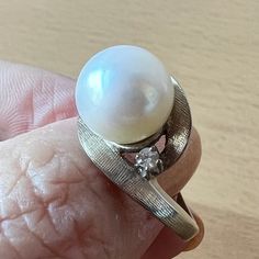 Stunning Vintage Ring In Solid 14k White Gold ( Stamped & Tested). When I Purchased It At The Rstate Sale, I Loved Everything About This Ring: The Heafty Chunky Setting, The Sparkling Diamonds On The Side, But The Pearl Was Dull So, My Jeweler Sent Me To The Pearl Wholeseller In The Nyc Jewelry District And Together We Chose This Beautiful, Round, White, Large 10mm Pearl For This Setting. When My Jeweler Set This New Pearl Into This Beautiful Vintage Setting, Its As If She Was Always There : A Perfect Match !!! Each Side Diamond Is Approx 2.3 Mm In Size , Genuine, Tested, I Do Not Have Color/ Clarity Info. Naked Eye Very Sparkly!!! So, This Is Truly A One Of A Kind Ring !!! Pearl Ring With Prong Setting For Anniversary, Formal White 14k Gold Pearl Ring, Round Cut Diamond Pearl Ring For Anniversary, Classic White Gold Pearl Ring With Diamond Accents, Timeless Pearl Ring With Diamond Accents For Anniversary, Timeless Anniversary Pearl Ring With Diamond Accents, Diamond Pearl Ring For Anniversary With Round Band, Anniversary Pearl Ring With Diamond Detail, Pearl Ring With Diamond For Anniversary