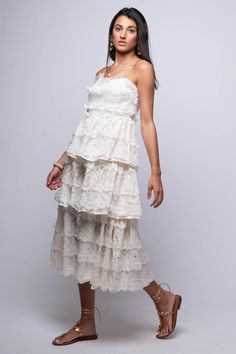 The Rumi Midi Dress is a simple yet elegant choice for any occasion. With its off-white color, tiered design, and lace detailing, this strapless bustier midi dress is sure to make you feel confident and stylish. Hand Wash 100% Cotton Import Fit Guide: Libby is 5ft 9 inches; Bust 34”, Waist 25”, Hips 34” Model is wearing a small True to size *Available at our Envy location