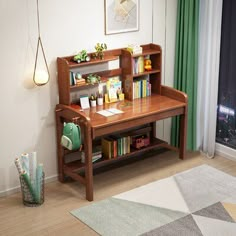 a wooden desk with books on it in front of a window and a rug next to it