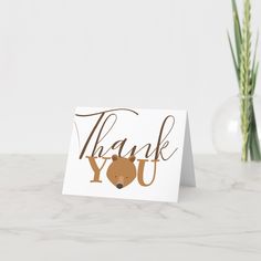 a thank card with the words thank you and a bear on it next to a plant