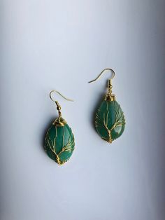 A pair of big charming teardrop-shaped green or pink hanging earrings, with gold wired tree of life wire wrapped artistically on the green or jade stones. They are so unique and eye-catching, hard to not notice when you wear them. Some highlights of these lovely gold family tree jade earrings are: *High-quality materials Quality green or pink jade stones, hand-wired in the tree of life wires. *Eye-catching design Simple and unique. The tree of life symbolizes the previous life, harmony, and fami Adjustable Wire Wrapped Bohemian Teardrop Earrings, Bohemian Adjustable Wire Wrapped Teardrop Earrings, Bohemian Teardrop Copper Wire Jewelry, Green Teardrop Nature-inspired Jewelry, Nature-inspired Green Teardrop Jewelry, Handmade Green Teardrop Earrings, Green Bohemian Earrings With Copper Wire, Bohemian Green Earrings With Copper Wire, Green Bohemian Copper Wire Earrings