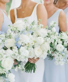 the bridesmaids are holding their bouquets in blue and white colors, while the groom is wearing a suit