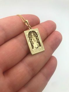 Elevate your spiritual style with our exquisite 14K Massif Gold Tarot Necklace featuring The High Priestess Card. Meticulously handcrafted, the rectangular pendant embodies the mystique of tarot symbolism, making it a unique and meaningful addition to your jewelry collection. This spiritual necklace serves as a powerful statement piece, blending craftsmanship with mysticism. An ideal gift for women who appreciate the fusion of elegance and spirituality, this handmade necklace captures the essenc Spiritual Rectangular Jewelry For Good Luck, Rectangular Spiritual Jewelry For Good Luck, Rectangular Spiritual Good Luck Jewelry, Spiritual Rectangular Good Luck Jewelry, Tarot Symbolism, Mystic Jewelry, Tarot Necklace, Spiritual Style, Spiritual Necklace