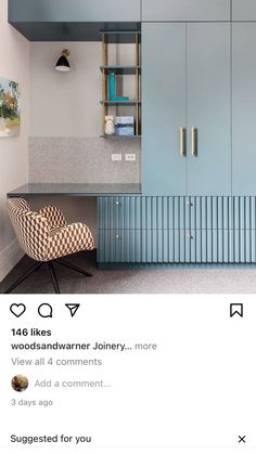 an image of a room with blue cabinets and a chair in front of the counter