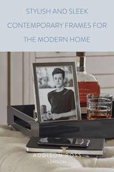 a bottle of alcohol and two glasses on a tray with the caption for modern interiors, choose our carbon fire frames