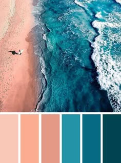 an aerial view of the beach with blue water and pink sand in the foreground