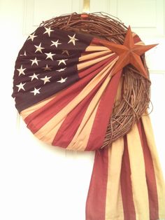 an american flag wreath hanging on the front door with a star spangled around it