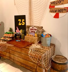 a table topped with lots of food next to a sign that says 25 on it