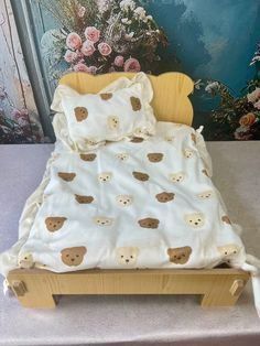 a bed with teddy bears on it in front of a wall