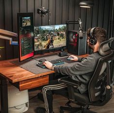 a man sitting in front of a computer with headphones on and playing video games