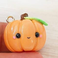 there is a small orange pumpkin with eyes on it