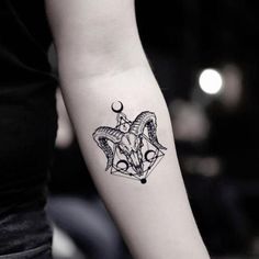 a woman with a goat head tattoo on her arm