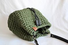 Crocheted handbag - BUCKET BAG* with shoulder strap (not adjustable), PU leather bottom, leather closing strap and two inside pockets. SIZE: 25x22x10 cm MATERIAL: 90% cotton, 10% polyester (fabric yarn - made from apparel/textile industry waste) COLOUR: Green, black. *item in the picture is the one you are getting Green Bucket Bag With Top Carry Handle, Cotton Shoulder Bag With Top Handle For Errands, Casual Green Bucket Shoulder Bag, Casual Green Shoulder Bucket Bag, Green Hobo Bag With Braided Handles, Cotton Shoulder Bag With Adjustable Strap For Errands, Green Backpack Shoulder Bag For Errands, Green Bucket Bag With Leather Handles, Green Backpack With Top Carry Handle