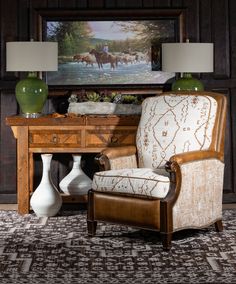 a living room with a chair, table and two vases on top of it