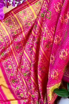 This beautiful single ikkat Patola saree in pink color is woven in narikunj design. The borders are woven in antique gold tissue with the ikkat design, and the pallu has a beautiful floral patterns. Approximate Length 6.5 mtrs (inclusive of blouse length)Height - 46 - 50" Saree comes with fall, picot and tassels done. Blouse piece is cut. Approximate weight - 1.2 lbs Kindly Note : The colors you see on your device may vary due to the color reproduction, brightness and resolution of individual devices. If you'd like more clarity before your purchase, please contact our support team. Multicolor Ikat Print Pre-draped Saree For Navratri, Pink Slub Silk Dupatta For Transitional Season, Navratri Ikat Print Pre-draped Saree, Pink Slub Silk Pre-draped Saree With Dupatta, Traditional Ikat Print Pre-draped Saree For Festivals, Pink Paithani Silk Pre-draped Saree For Traditional Ceremonies, Pink Bohemian Pre-draped Saree For Festive Occasions, Bohemian Pink Pre-draped Saree For Festive Occasions, Festive Pink Bohemian Pre-draped Saree