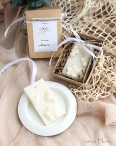 a soap bar sitting on top of a white plate next to a box of soap