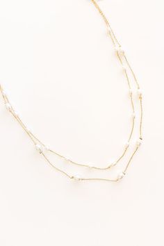 - Add gorgeous layers of luxe style to your - OOTD with this beautiful necklace - Gold colored metal material - Two petite chains for a layered look - Faux pearl accents - An adjustable length chain and clasp closure - Length: 16.5-18.5 inches White Multi-strand Double Chain Necklace, Pearl Chain Layered Necklace As A Gift, Multi-strand Layered Pearl Necklace For Party, Multi-strand Layered Pearl Chain Necklace For Parties, Multi-strand Pearl Chain Necklaces, Delicate Double Strand Layered Necklace With Adjustable Chain, Multi-strand Pearl Jewelry With Adjustable Chain, White Multi-strand Necklace With Double Chain, Pearl Necklace With Chain For Layering