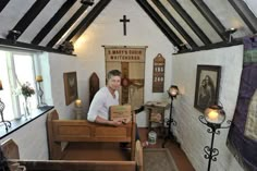 a man sitting in a chair inside of a church