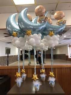 balloons with teddy bears sitting on the moon and stars hanging from it's sides