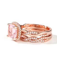 two rose gold wedding rings with an oval pink morganite center surrounded by round diamonds