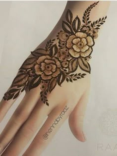 a hand with flowers on it is shown in the image, and has an intricate design