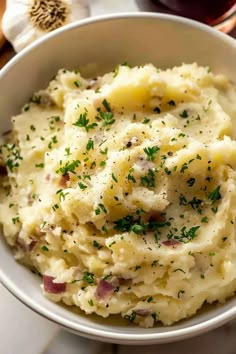 a bowl filled with mashed potatoes and garnished with parsley