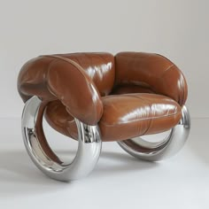 a brown leather chair sitting on top of a metal frame