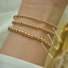 ** BUY ANY THREE (3) ITEMS AND GET 20%OFF ON YOUR ENTIRE PURCHASE ** Gold Bead Bracelet, Beaded Bracelet, Gold Bracelet, 18K Gold Filled Bead Bracelet, Stacking Bracelet 2mm 3mm 4mm, Dainty Bracelet Classic 18k gold-filled bead bracelet is a perfect addition to a dainty stack this spring/summer season. The beads are strung on a premium stretch cord. SOLD BY ONE BRACELET ITEMS DETAILS: Water Resistant -Nickel-free - Allergy-free - Hypoallergenic - 18K gold-filled bead bracelets - round bead size Flexible Bracelets With Tiny Beads As A Gift, Flexible Jewelry With 8mm Beads As Gift, Flexible Jewelry With 8mm Beads For Gift, Minimalist Hypoallergenic Beaded Round Bracelets, Minimalist Hypoallergenic Round Beaded Bracelets, Minimalist Hypoallergenic Beaded Bracelet, Handmade Dainty Rosary Bracelet With Round Beads, Dainty Handmade Rosary Bracelet With Round Beads, Handmade Dainty Rosary Bracelet