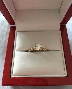 an engagement ring in a red box