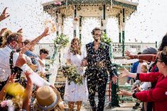 people are throwing confetti in the air at a wedding