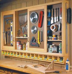 a workbench with many tools hanging on the wall