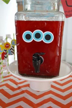 a red drink dispenser sitting on top of a table