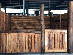 several wooden fences are lined up against each other in an enclosed area with concrete flooring