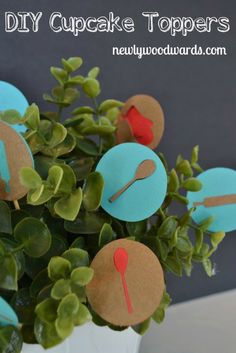 there is a potted plant with paper cutouts on it and some green leaves