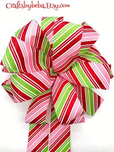 a red, green and pink striped bow on a white background with the words craftsbyeba easy com