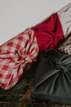 three different types of bow ties laying on top of each other, one black and one red