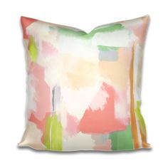 an abstract pillow with pink, green and yellow paint strokes on the front side of it